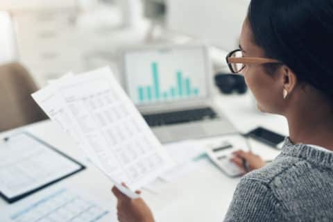 Closeup shot of a businesswoman calculating finances in an office