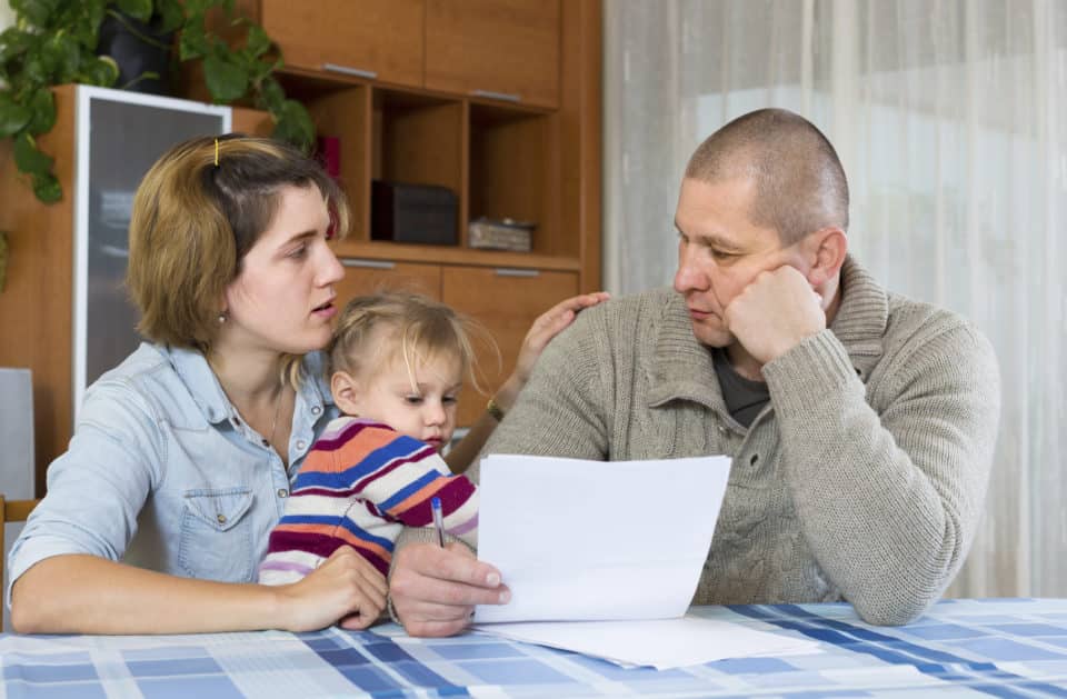 Worried family reviewing financial documents